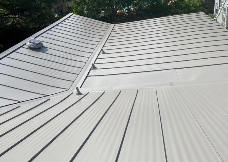 Solar attic fan installed on a metal roof for Roof Ventilation in Lawrence